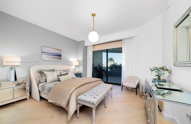 bedroom featuring access to exterior and light hardwood / wood-style flooring