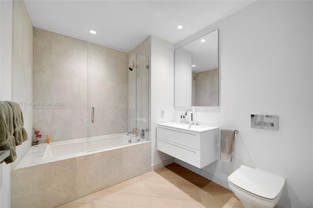 full bathroom with vanity, tiled shower / bath, and toilet