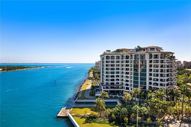 exterior space with a water view and a beach view