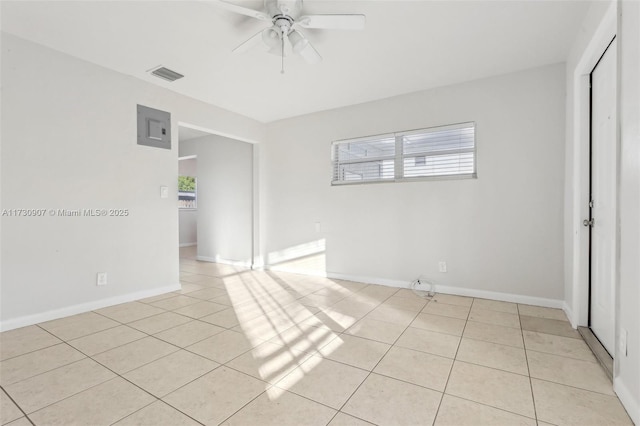 tiled empty room with ceiling fan