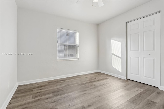 empty room featuring ceiling fan and light hardwood / wood-style floors