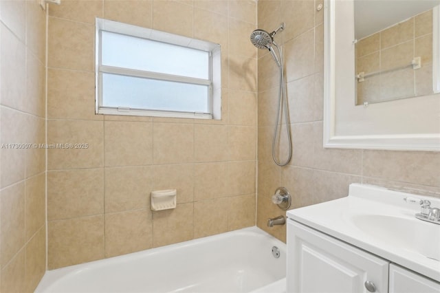 bathroom with vanity and tiled shower / bath