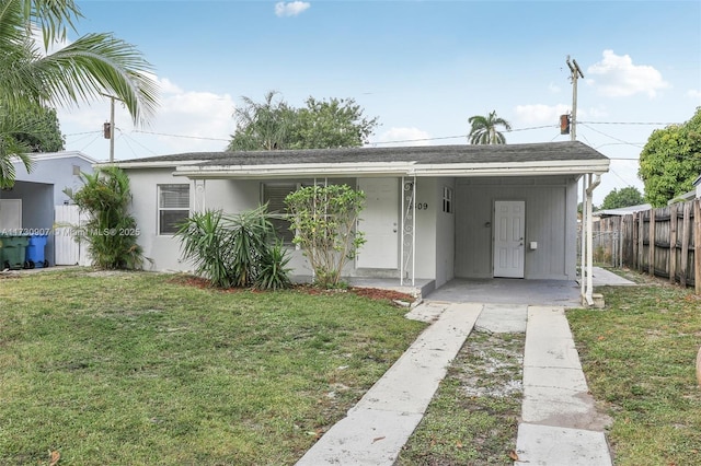 view of front of house with a front lawn and a carport