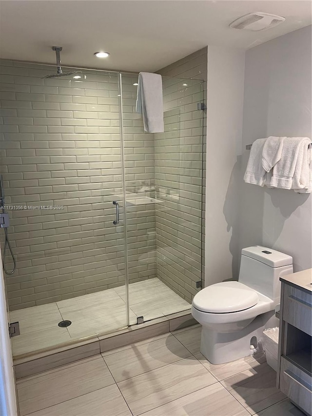 bathroom with walk in shower, vanity, toilet, and tile patterned flooring