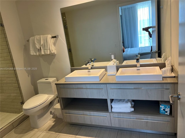 bathroom with vanity, toilet, and tile patterned flooring