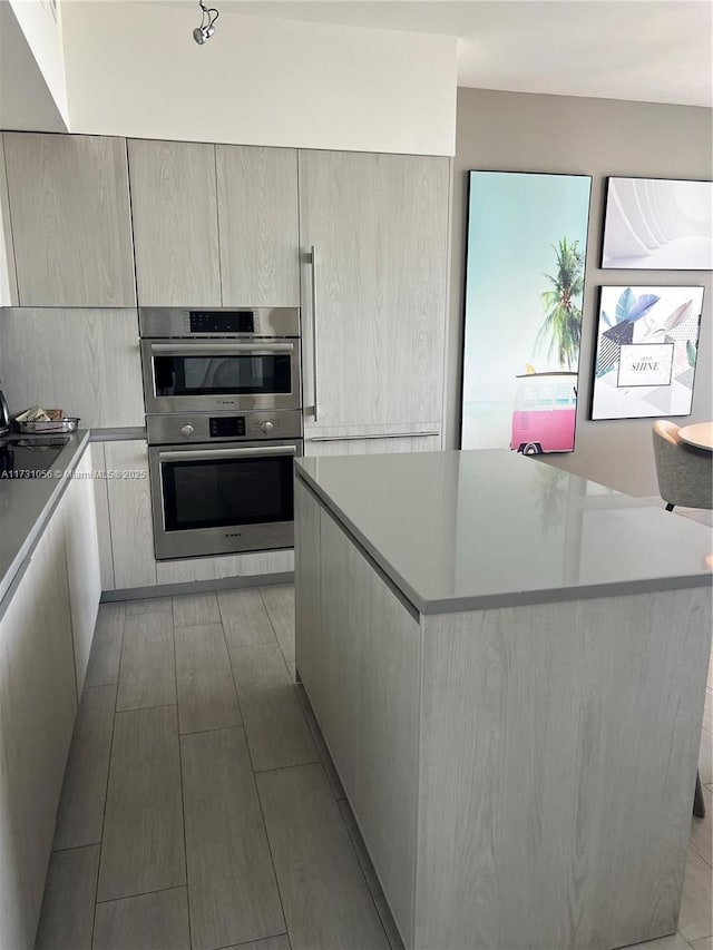 kitchen with sink, a center island, and double oven