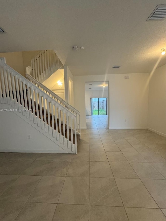 stairs with tile patterned floors