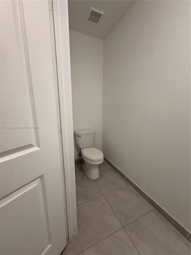 bathroom featuring toilet and tile patterned flooring