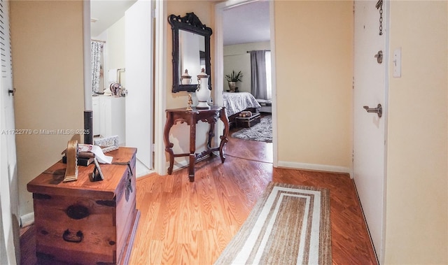 hallway with hardwood / wood-style floors