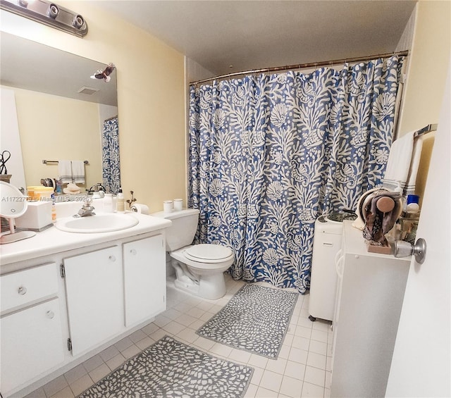 bathroom with tile patterned floors, vanity, and toilet