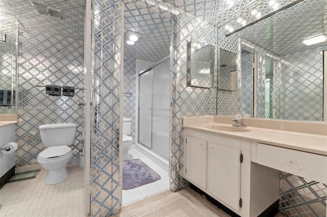 bathroom with tile patterned flooring, tile walls, an enclosed shower, and toilet