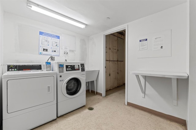 washroom with washer and dryer