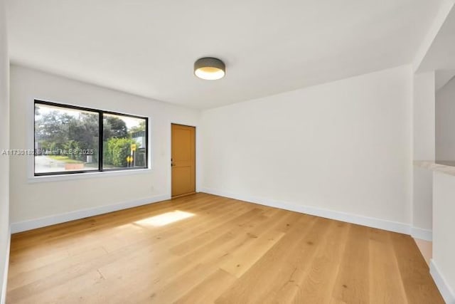 spare room with wood-type flooring