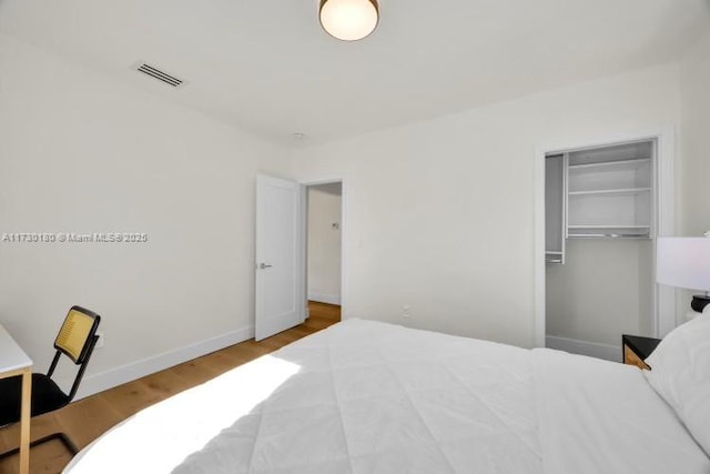 bedroom with hardwood / wood-style floors and a closet