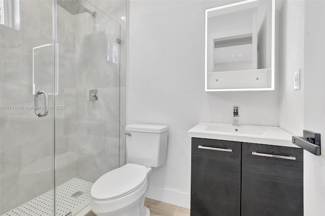 bathroom featuring tile patterned floors, toilet, vanity, and an enclosed shower