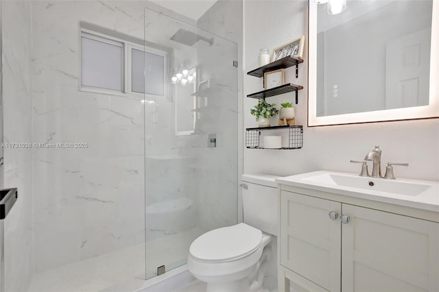 bathroom with vanity, toilet, and tiled shower