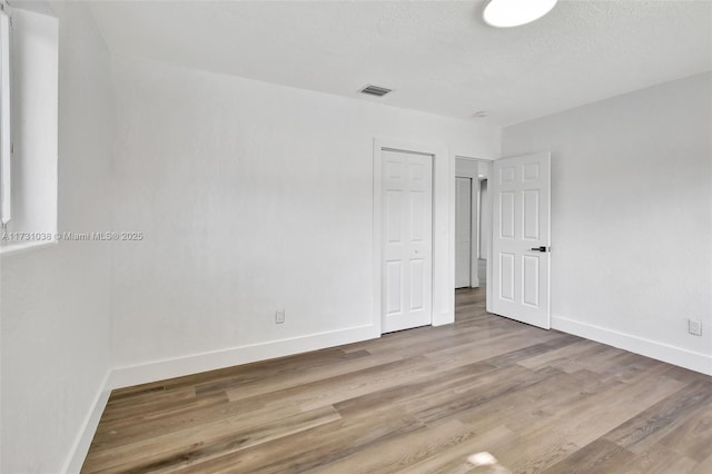 spare room with hardwood / wood-style floors