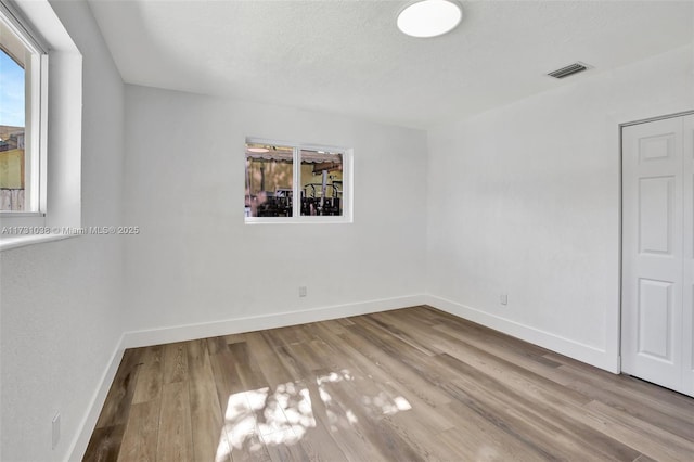 empty room with light hardwood / wood-style floors