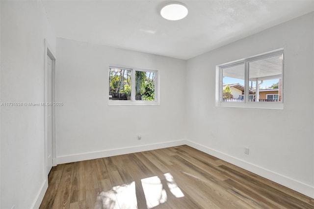 unfurnished room with wood-type flooring