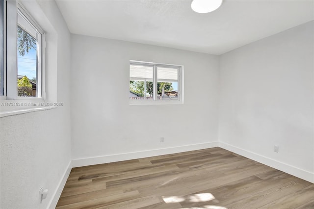 spare room with light wood-type flooring