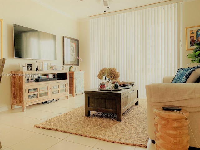living area featuring ornamental molding, tile patterned flooring, and ceiling fan