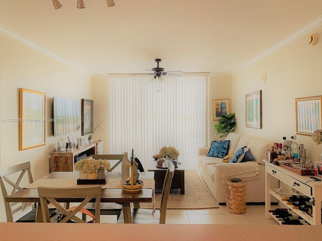 living room with ceiling fan, light tile patterned floors, and crown molding