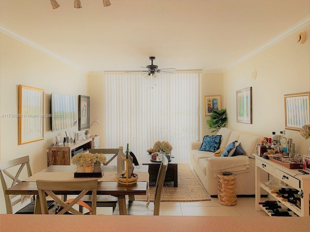living room with a ceiling fan, light tile patterned flooring, and ornamental molding