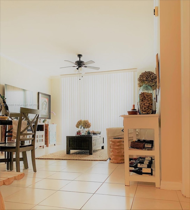 living area featuring ceiling fan and tile patterned flooring