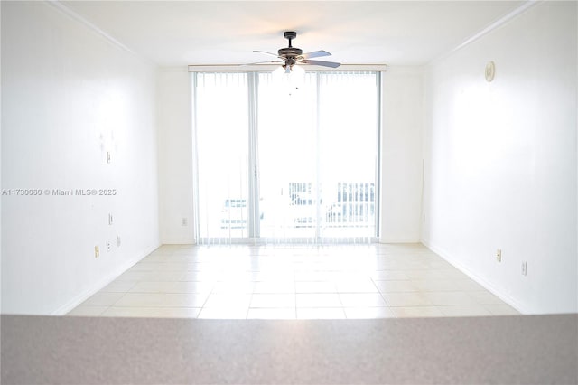 spare room featuring ceiling fan, a healthy amount of sunlight, and crown molding