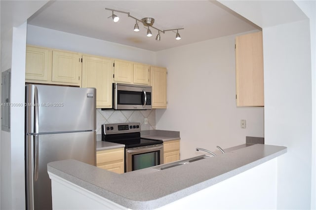 kitchen with a sink, light brown cabinetry, backsplash, and appliances with stainless steel finishes