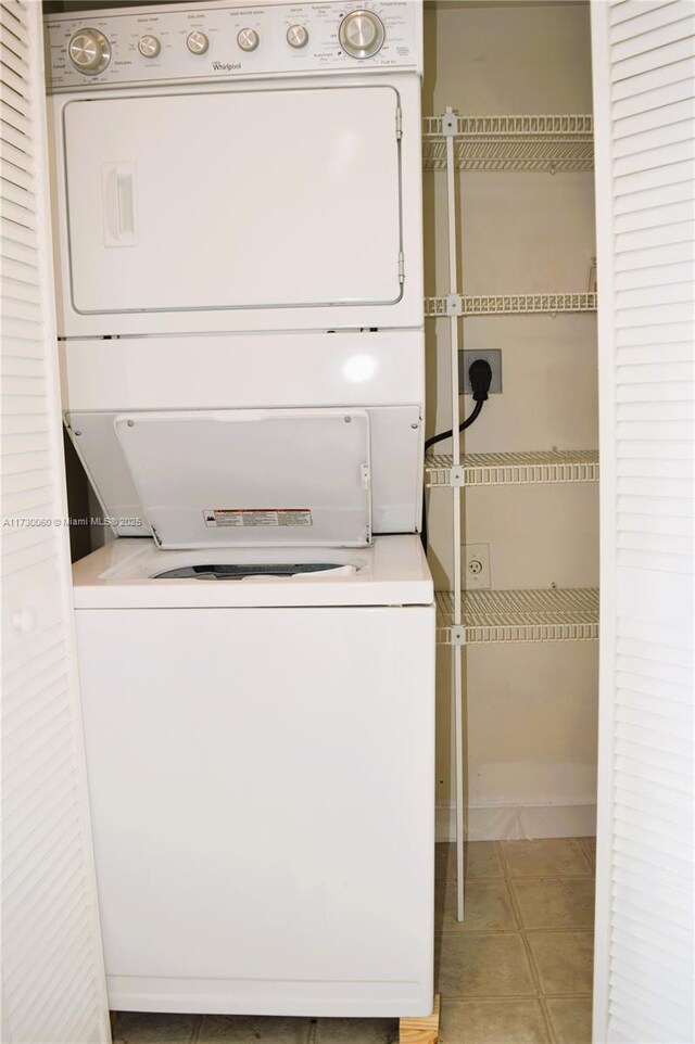 2665 SW 37th Ave Unit 613, Miami, FL 33133 - laundry room featuring light tile patterned flooring, stacked washing maching and dryer, and laundry area