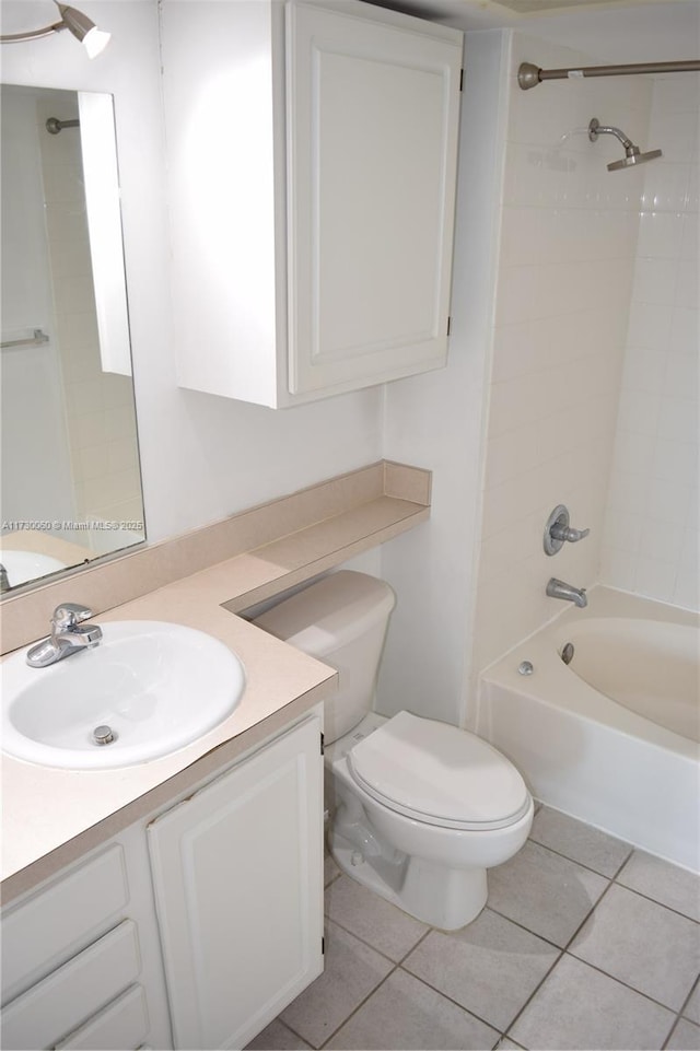 bathroom with shower / bathing tub combination, toilet, tile patterned flooring, and vanity