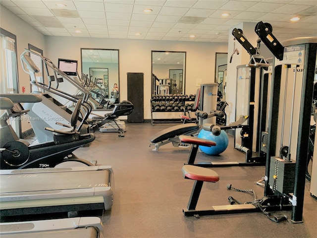 gym featuring recessed lighting and a paneled ceiling