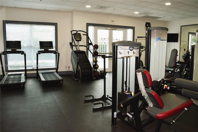 gym with baseboards, a drop ceiling, and recessed lighting