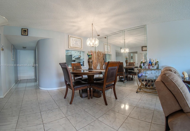 dining space featuring a textured ceiling and an inviting chandelier