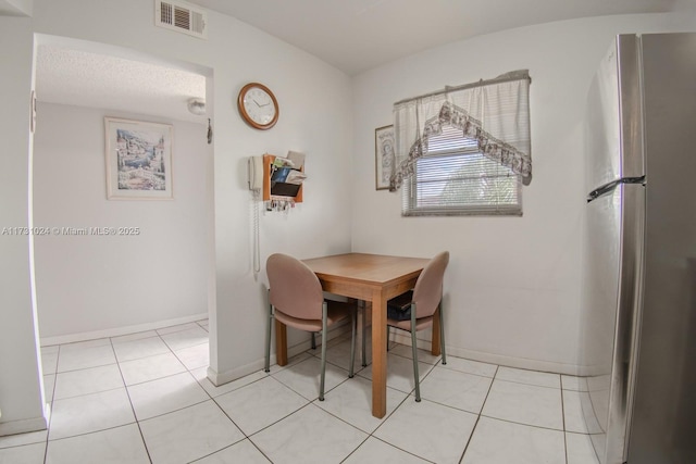 dining area featuring light tile patterned floors