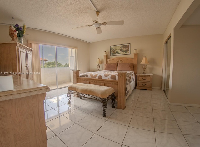 tiled bedroom featuring ceiling fan, access to exterior, and a textured ceiling