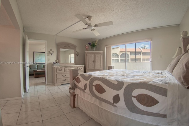 bedroom featuring ceiling fan, light tile patterned floors, and a textured ceiling