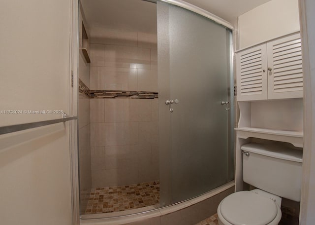 bathroom featuring walk in shower and toilet