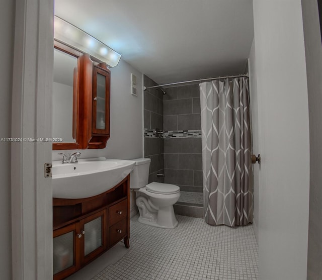 bathroom featuring vanity, toilet, a shower with shower curtain, and tile patterned flooring