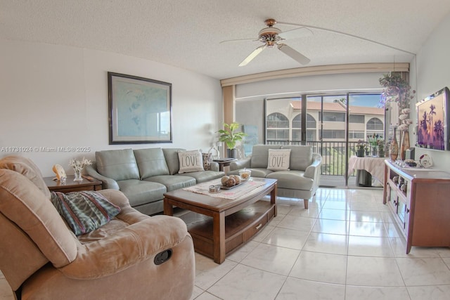 living room with light tile patterned flooring, a textured ceiling, and ceiling fan