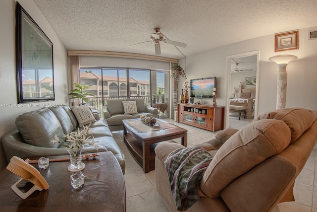 living room with ceiling fan and a textured ceiling