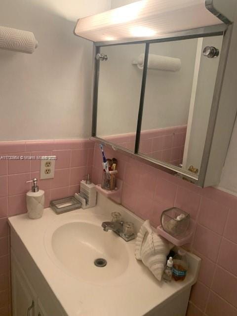 bathroom featuring tile walls and vanity