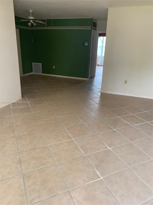 spare room featuring tile patterned flooring, baseboards, and visible vents