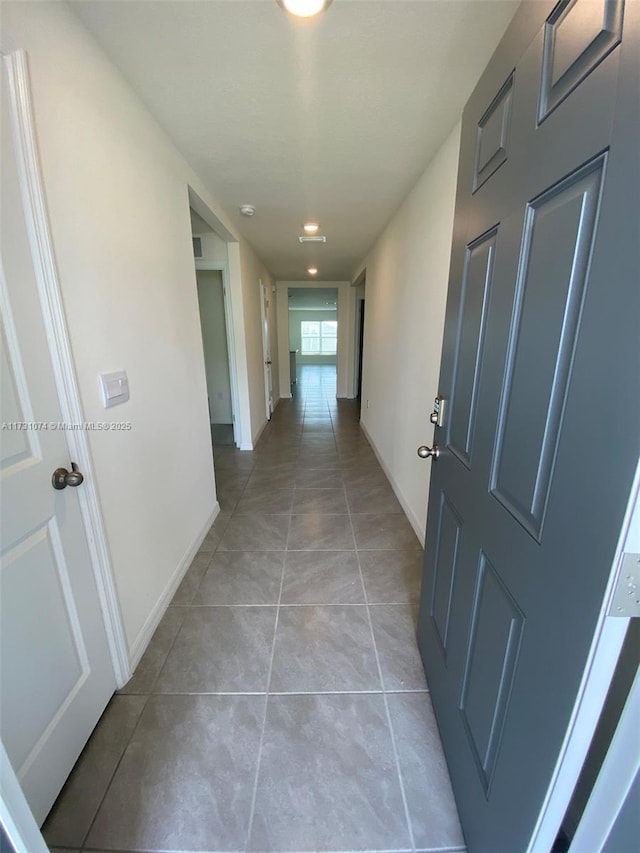 corridor with light tile patterned floors