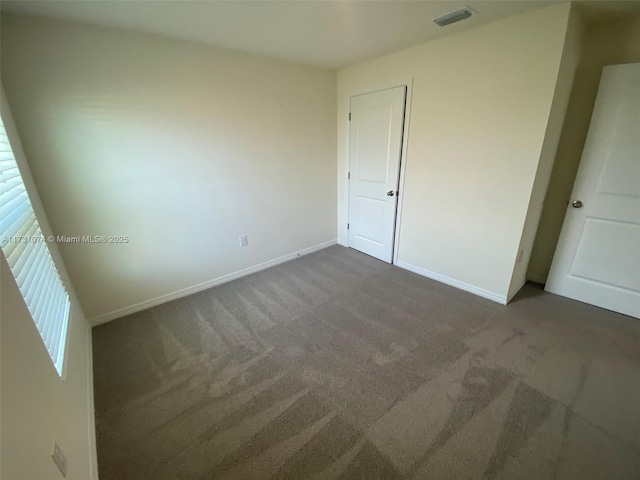 unfurnished bedroom featuring dark carpet