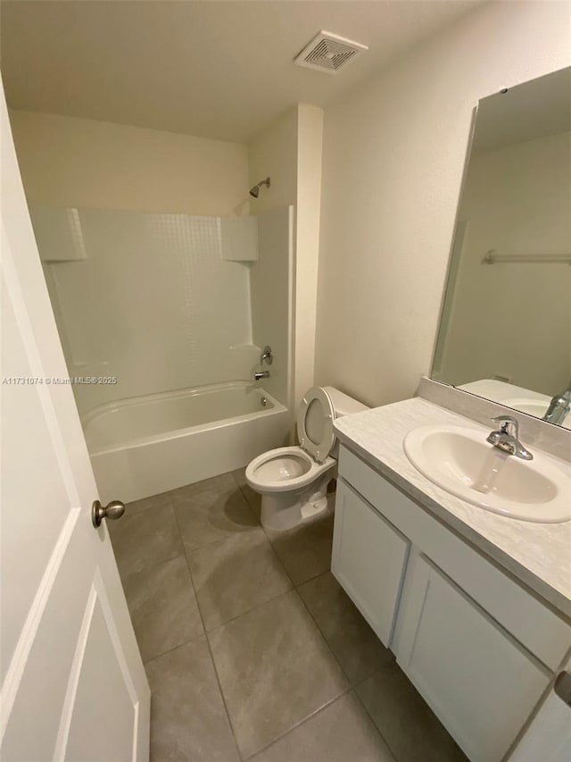 full bathroom featuring vanity, bathtub / shower combination, tile patterned floors, and toilet