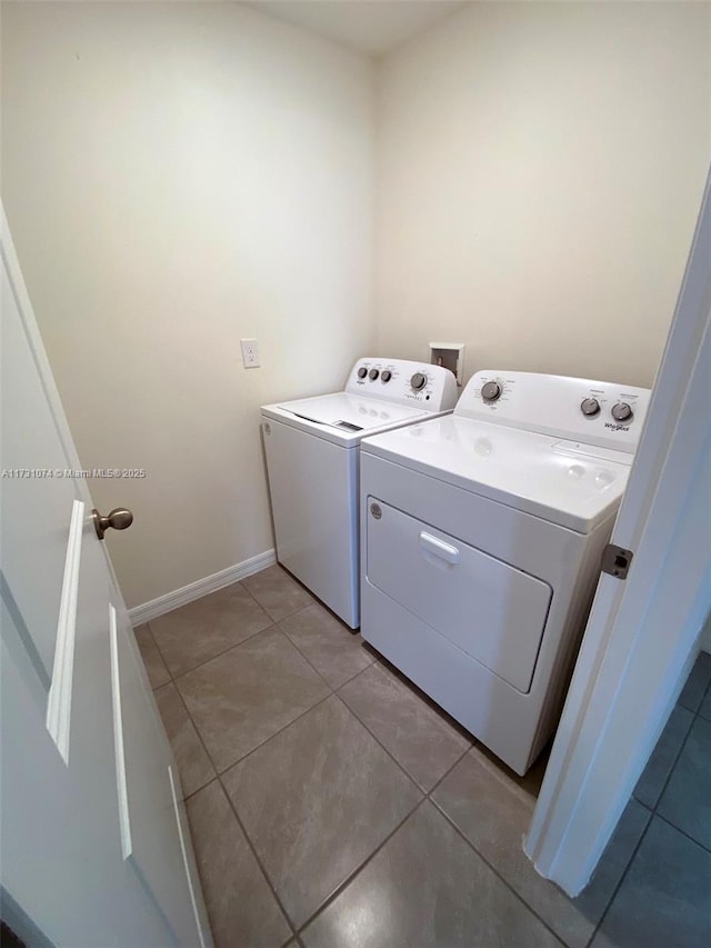 laundry area featuring separate washer and dryer and light tile patterned flooring