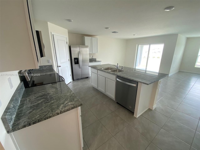 kitchen with white cabinetry, sink, a center island, and appliances with stainless steel finishes