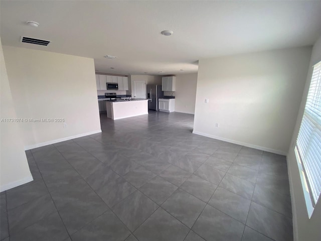 unfurnished living room with a wealth of natural light